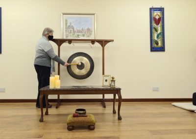 Miriam ringing the gong in the new meditation room