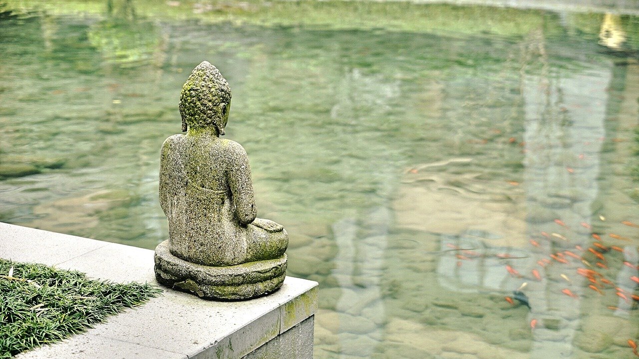 Photo of Buddha overlooking a pond